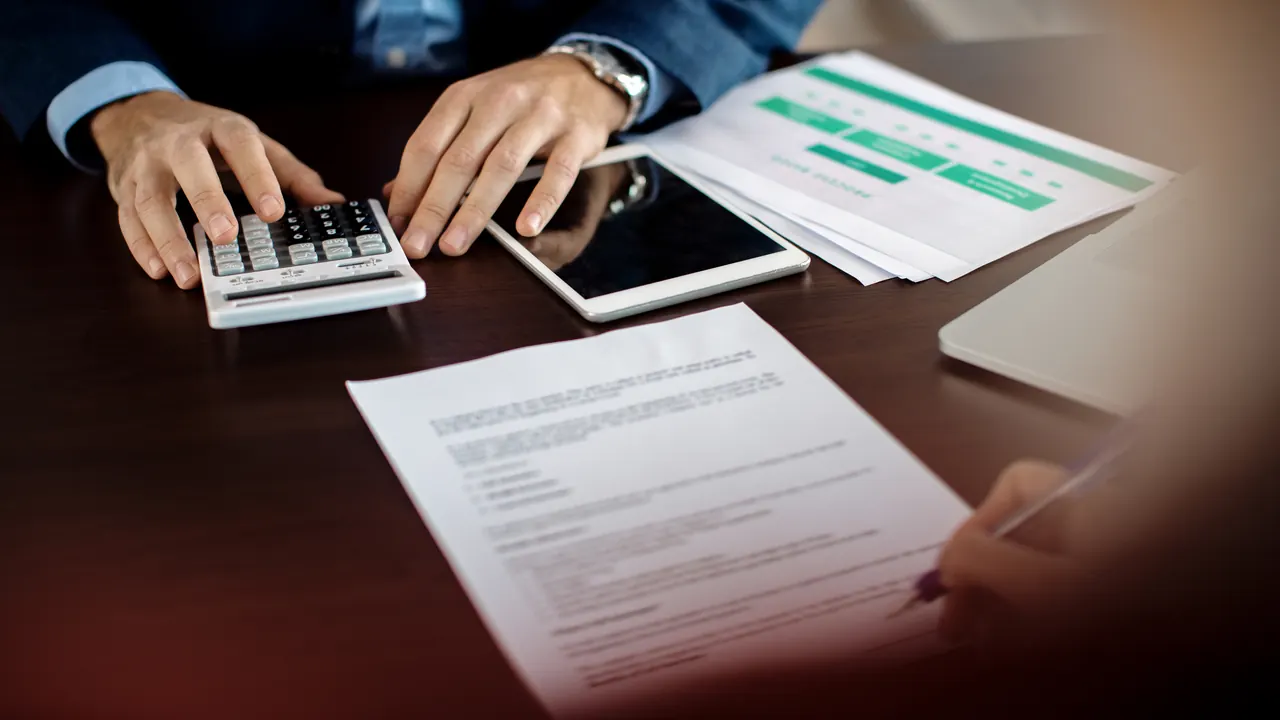 Tax calculation with a calculator and documents