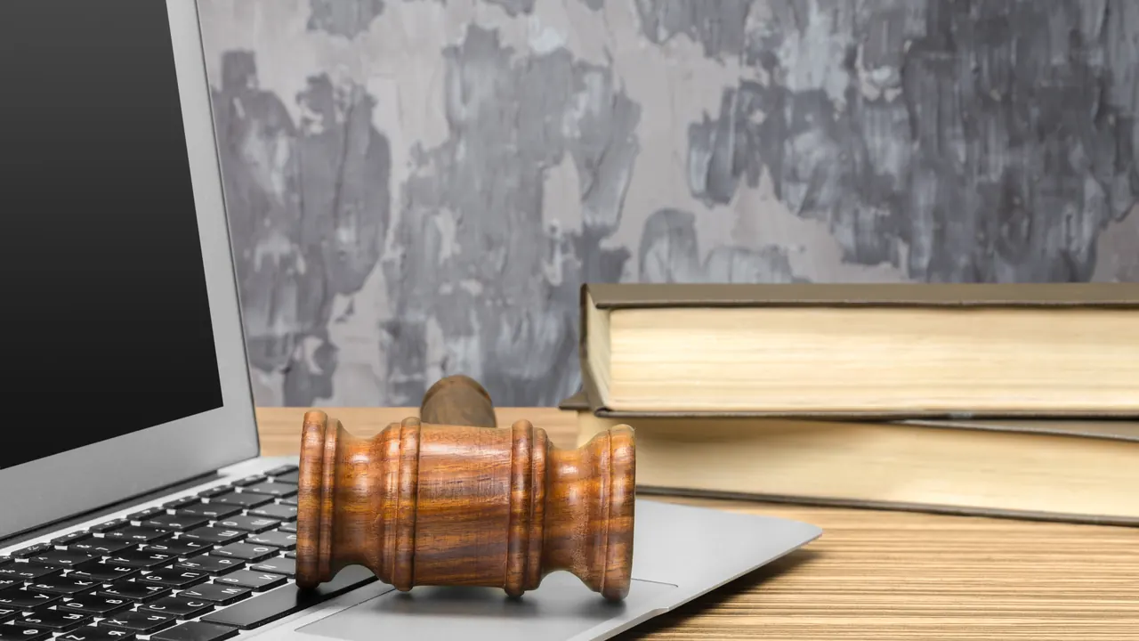 Judge's gavel next to a laptop