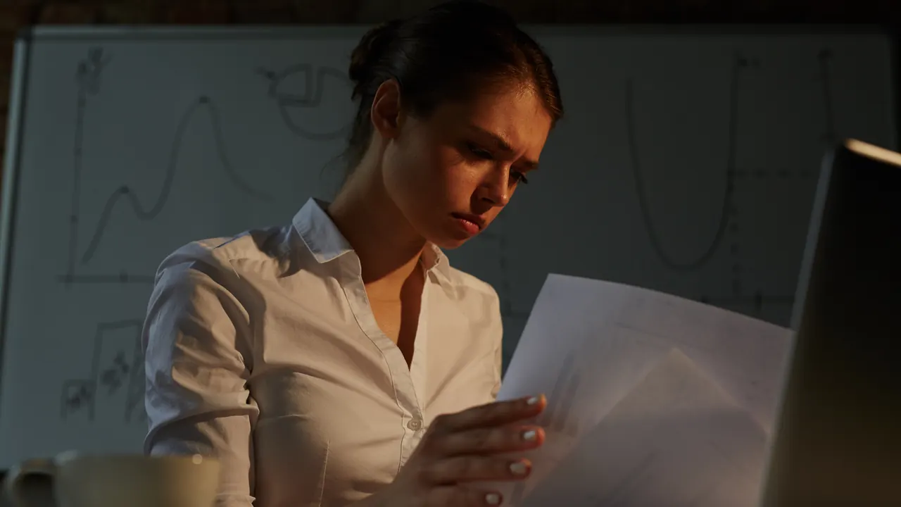 Professional reviewing documents at night