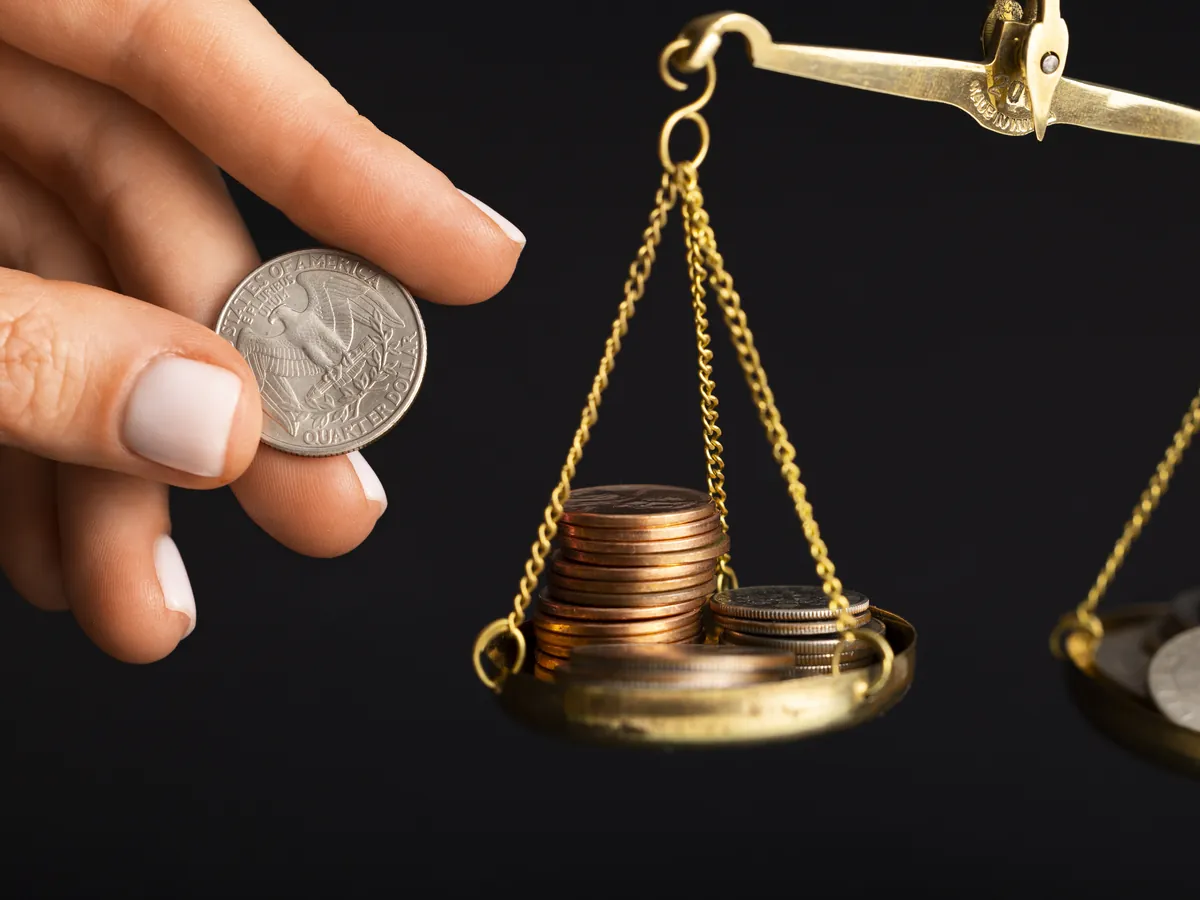 Scale with coins, a symbol of compliance and regulation