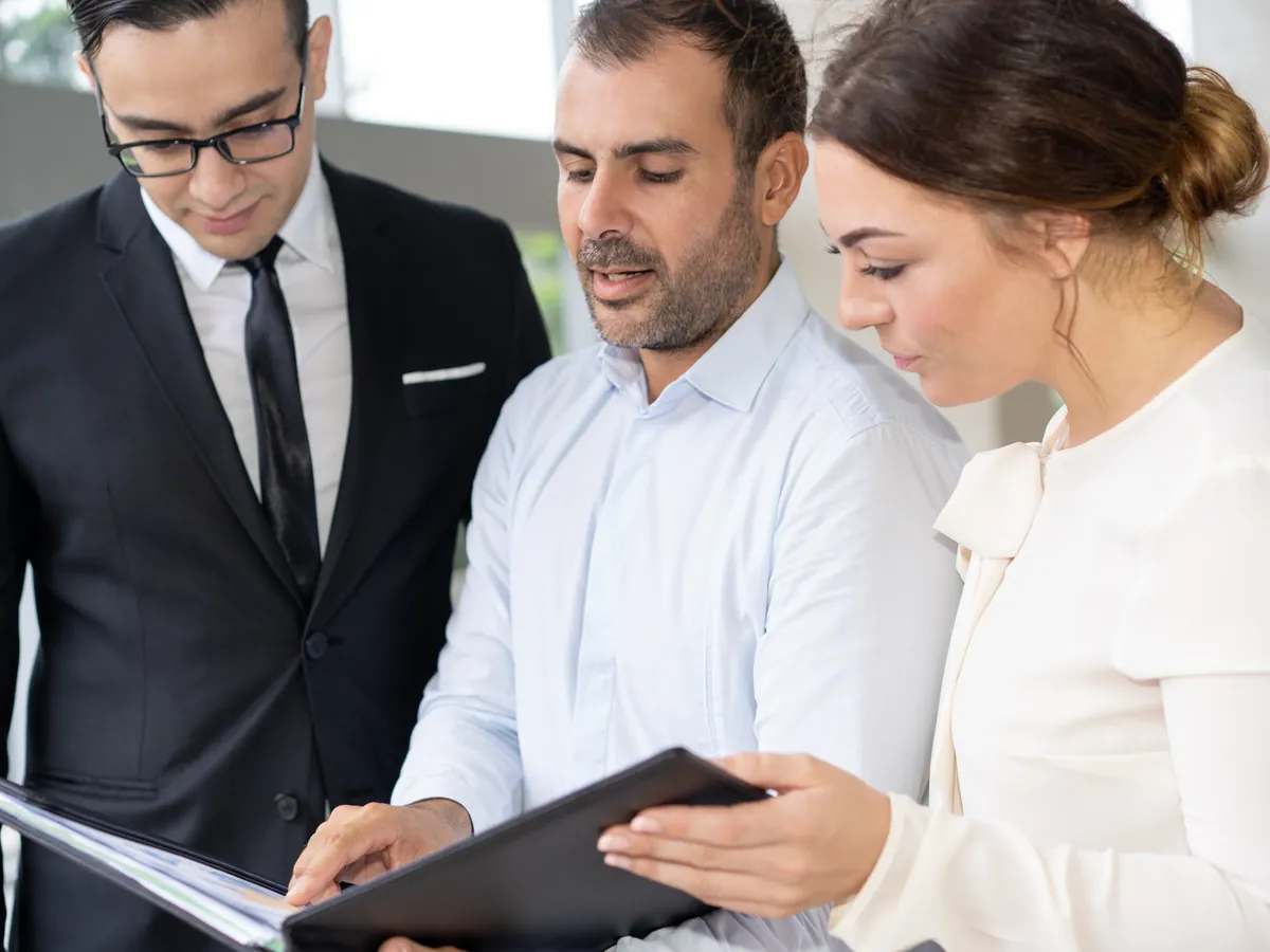 Team reviewing reports and process charts in a meeting